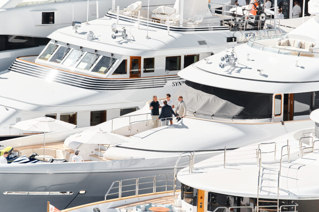 Four people having a conversation on the front of a yacht